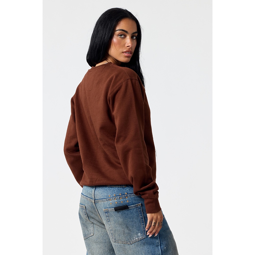 A woman in the 103 essential crew sweatshirt in chocolate, seen from behind