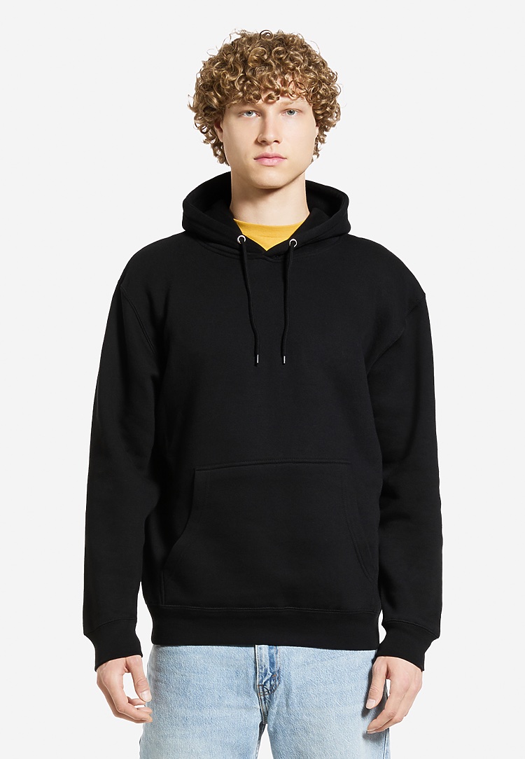 A man in the LS14001 premium pullover hoodie in black, from the front